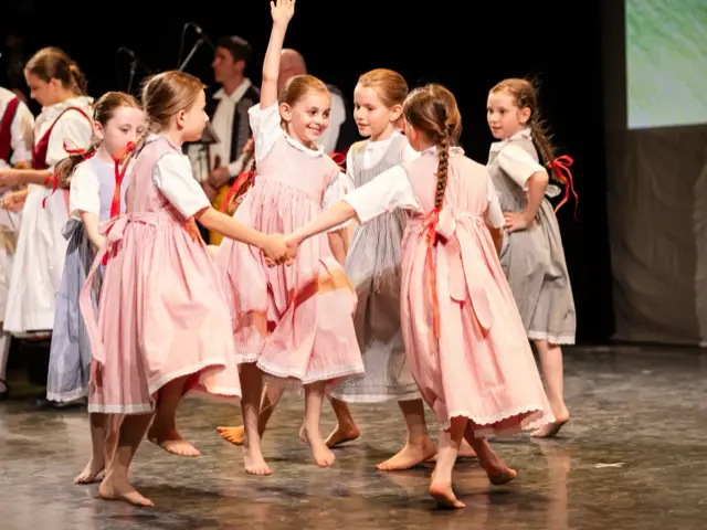Children of the youngest group dancing in pink costumes